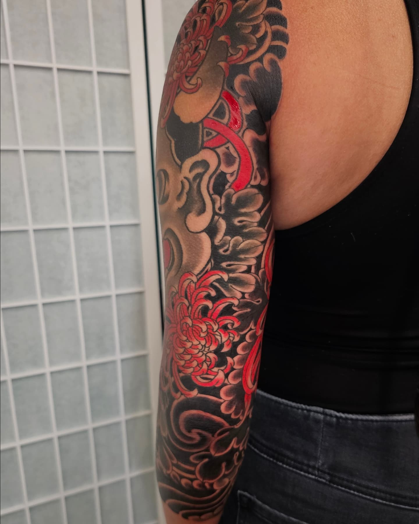 Chrysanthemum and dragon japanese irezumi tattoo on the upper arm by Avelourd Legaspi