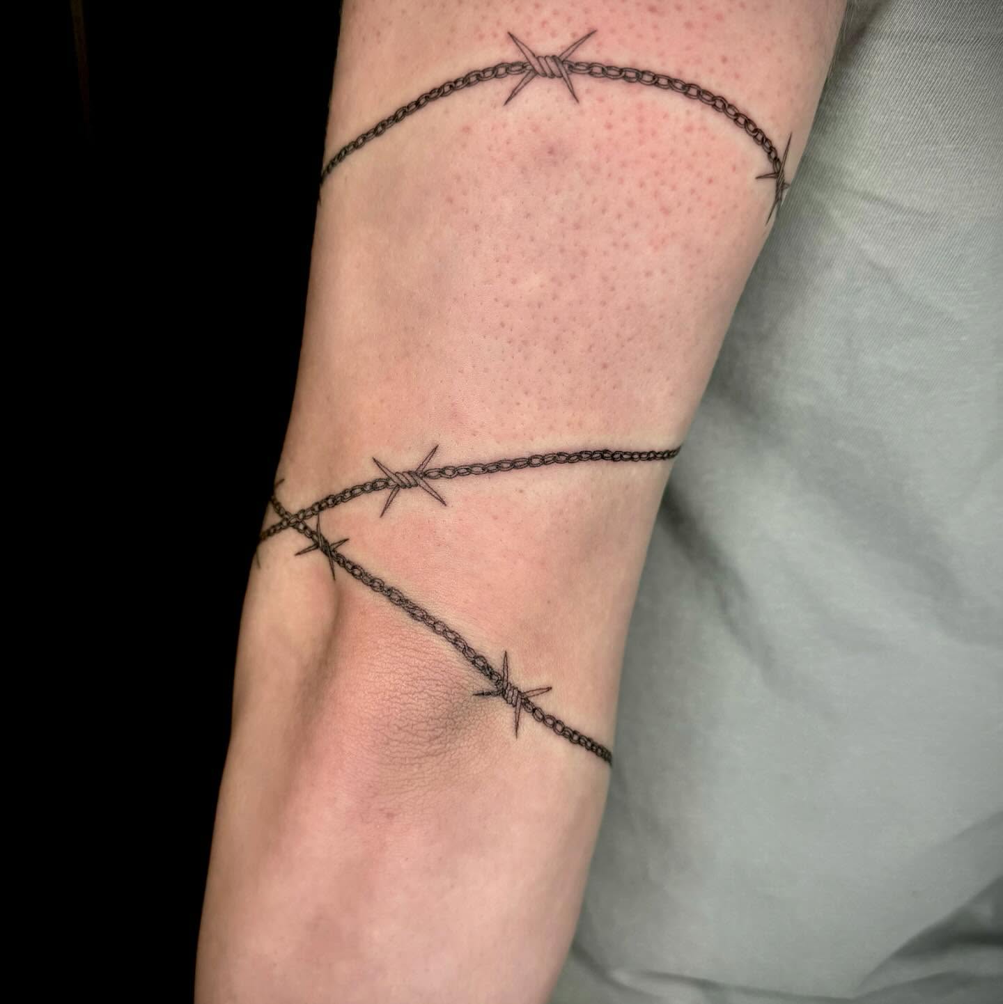 Barbed wire black and grey tattoo on the forearm by oh hey, robin.