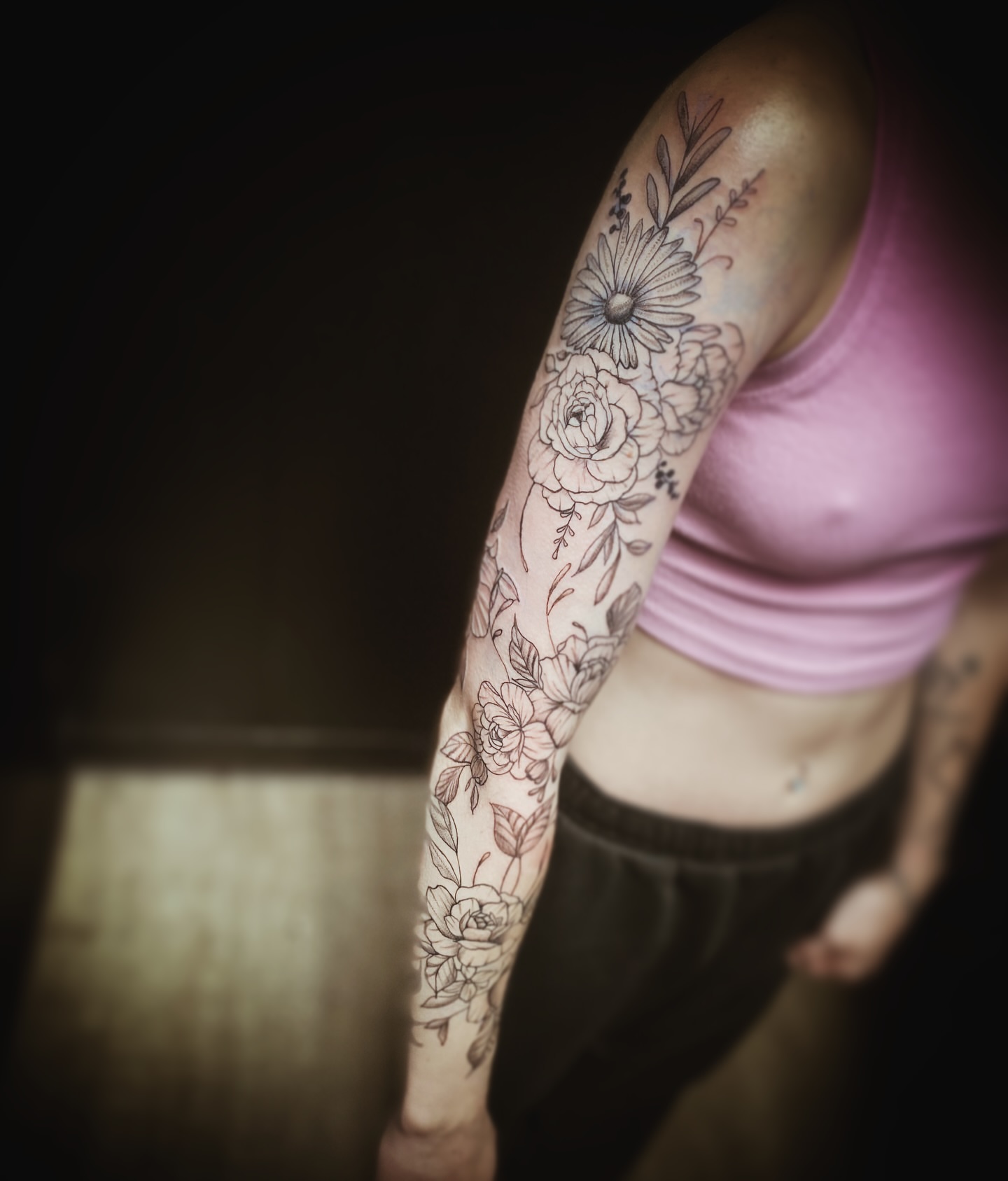 Floral bouquet black and grey tattoo on the forearm by Rico Rosario