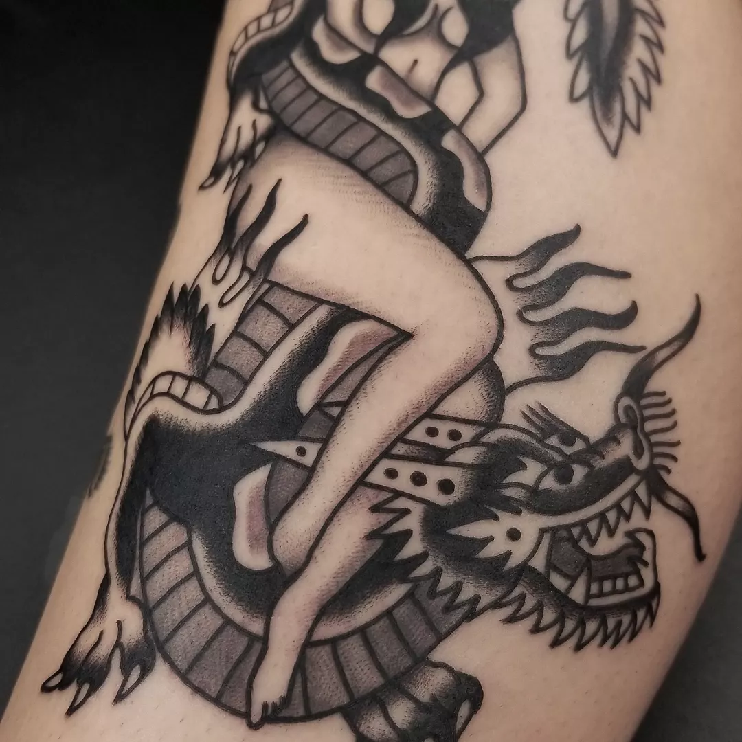 Woman riding dragon American traditional tattoo on the upper arm by Deke Harms, Bend, Oregon