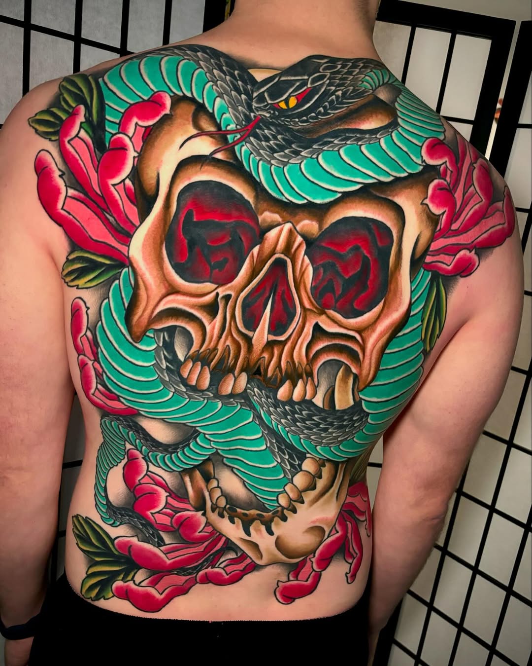 Skull with snake and flowers Japanese tattoo on the back by Mickey Putillo, Charlotte, North Carolina