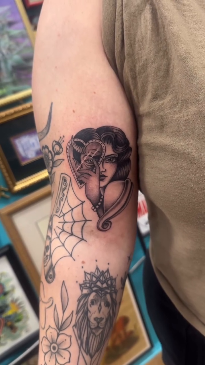 Woman's face with heart neo-traditional tattoo by Arielle Deatherage
