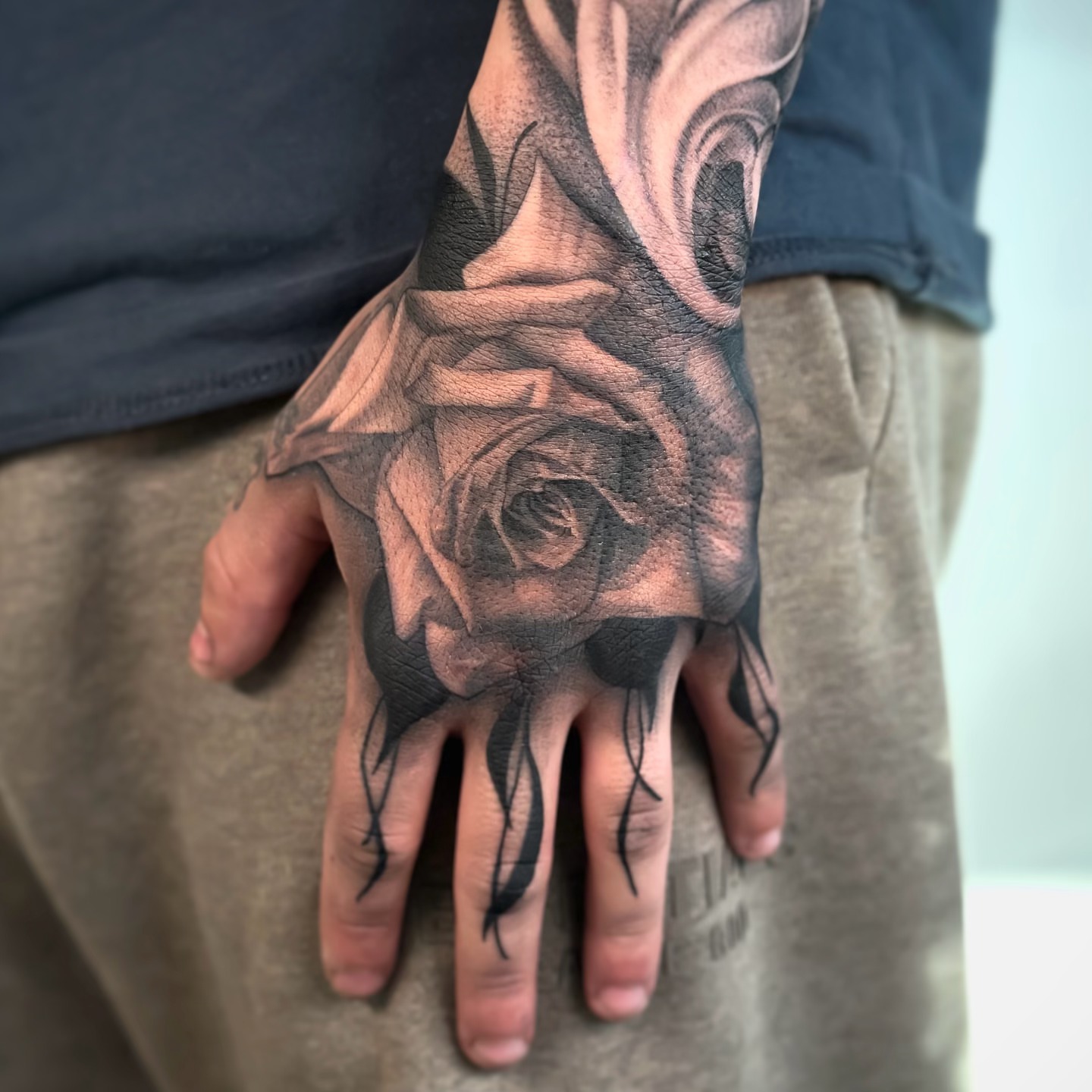 Rose realism tattoo on the hand by Paige Jean