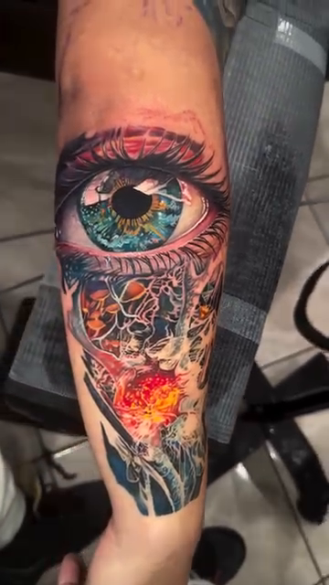 Eye and mechanical parts realism tattoo by James Moyer