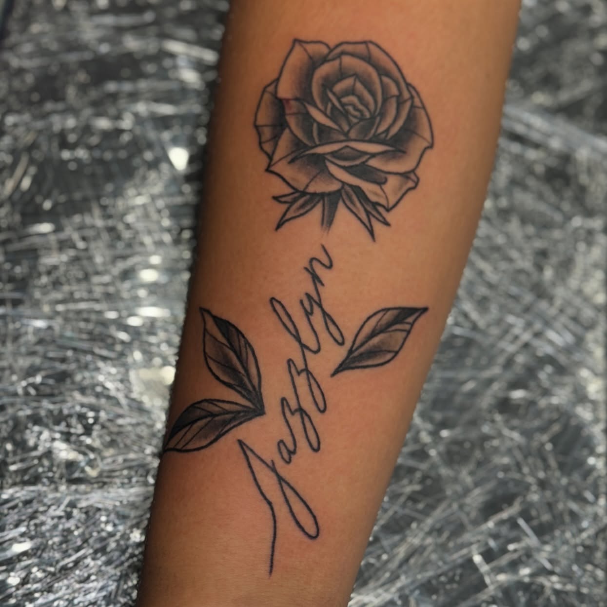 Rose and name realism tattoo on the forearm by Ashley Rose - Minnesota Tattoo Artist