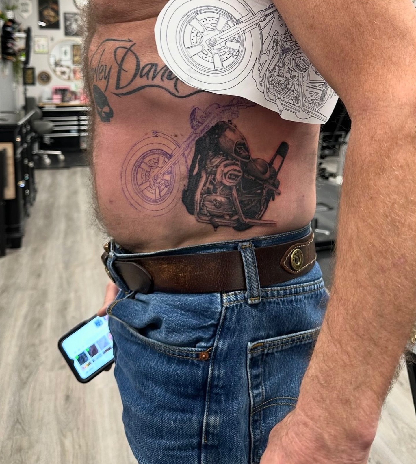 Motorcycle realism tattoo on the torso by Kelsey Zussman