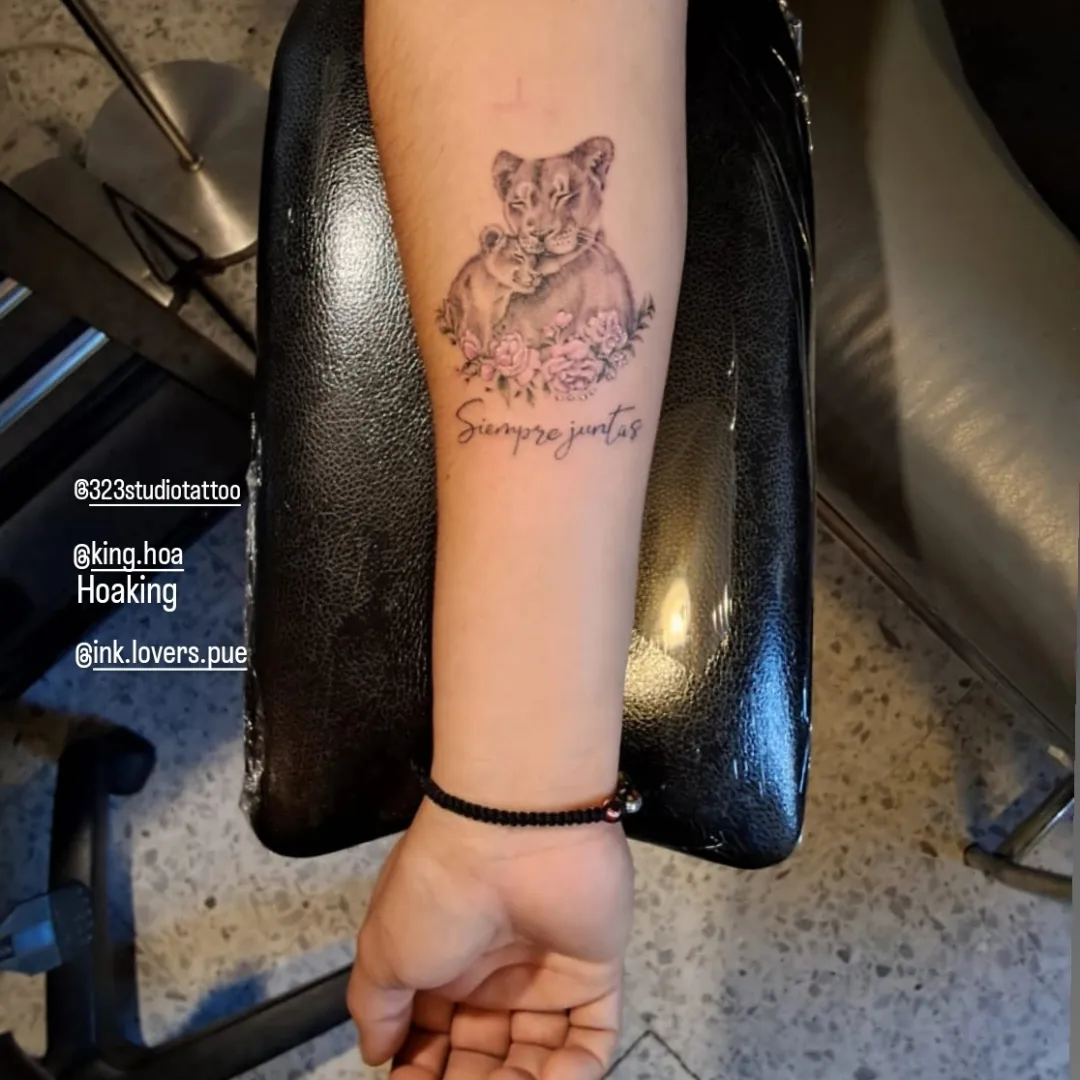 Lioness and cub realism tattoo on the forearm by Hoa King