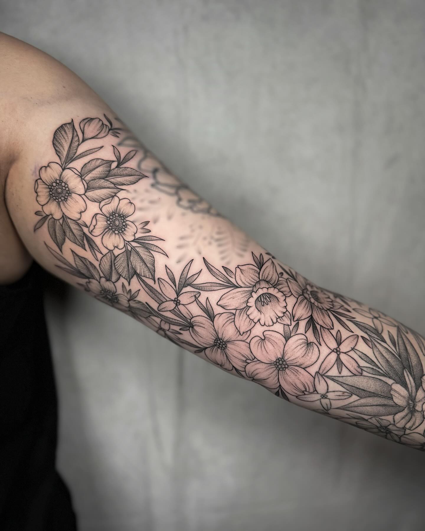 Floral bouquet black and grey tattoo on the forearm by Mallory Miller π³οΈβπ Eugene