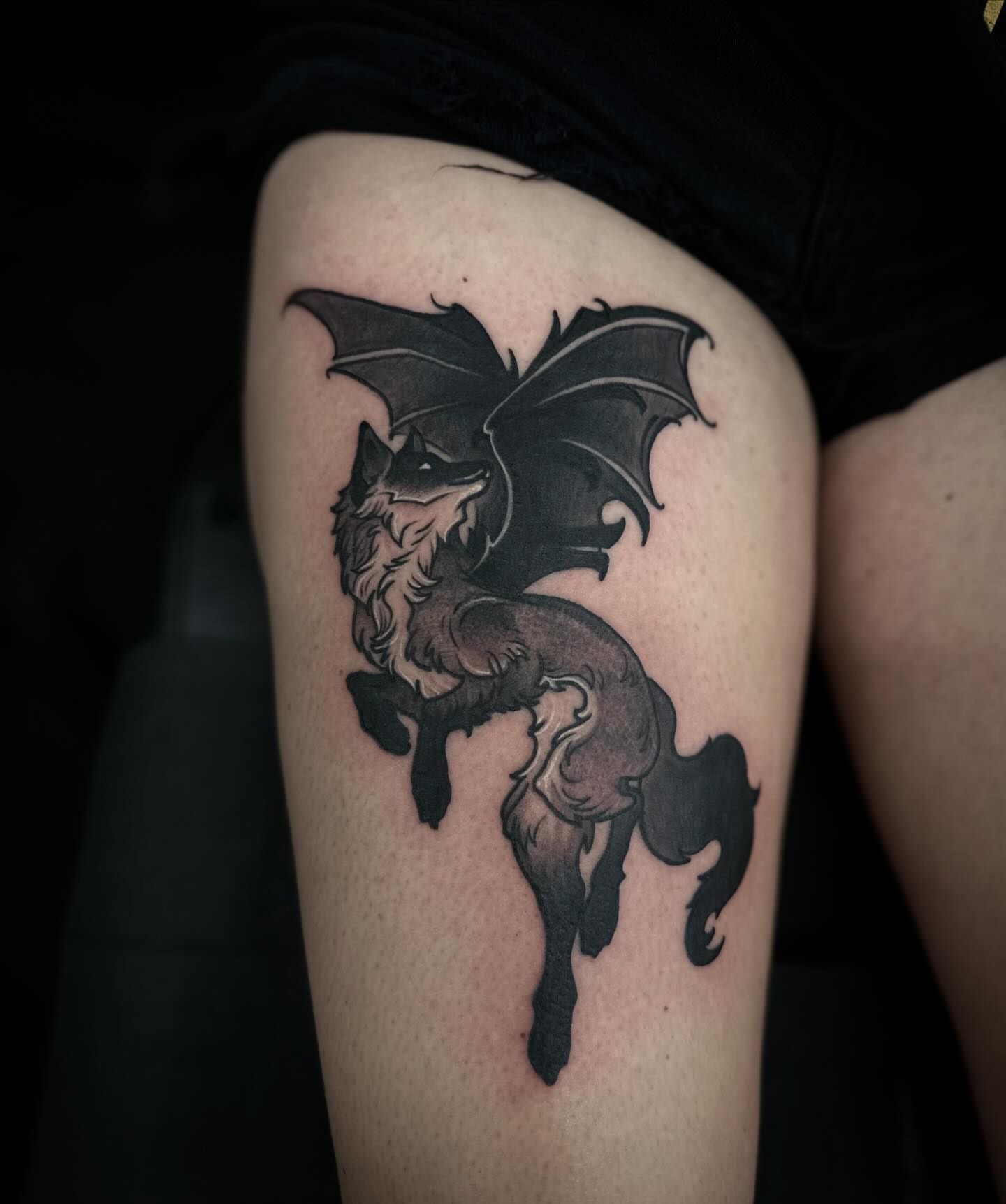 Fox with wings black and grey tattoo on the thigh by 𝕽𝖎𝖌𝖊𝖗𝖘 𝕳𝖆𝖒𝖟𝖆, San Francisco, California