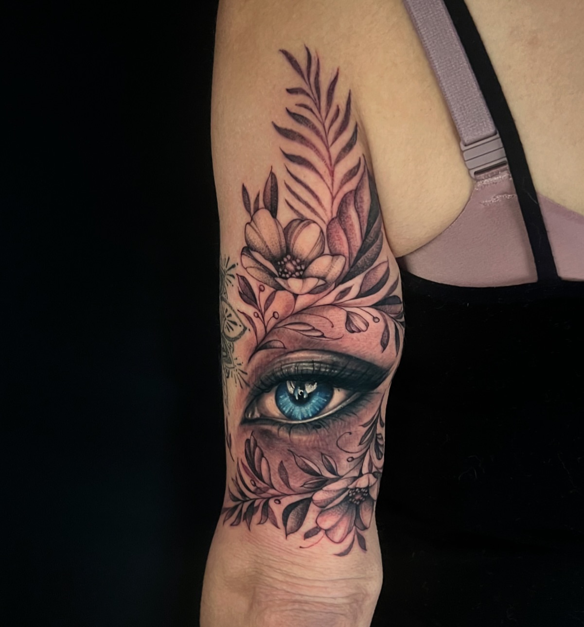 Eye with floral design realism tattoo on the forearm by Chelsea Speirs