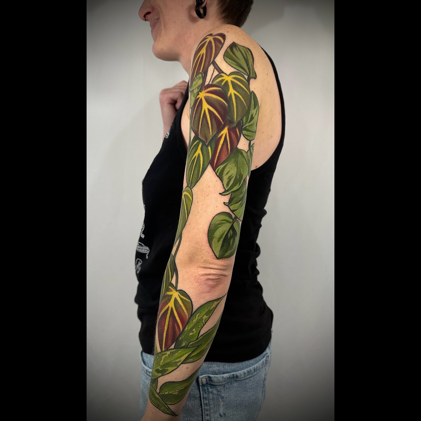 Botanical leaves realism tattoo on the upper arm by ✨Sarah Knapp✨, Eugene, Oregon