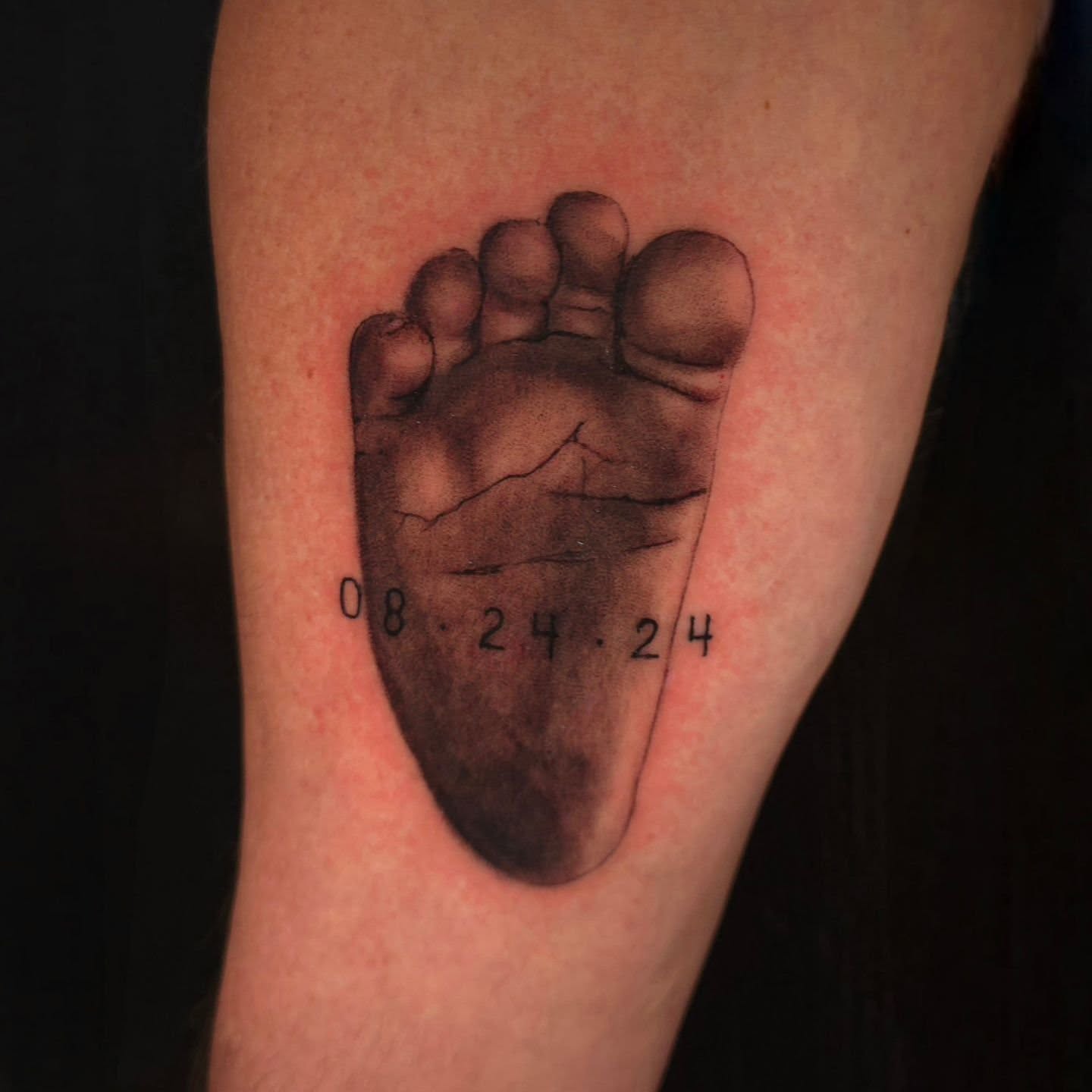 Footprint black and grey tattoo on the forearm by BoogaInk