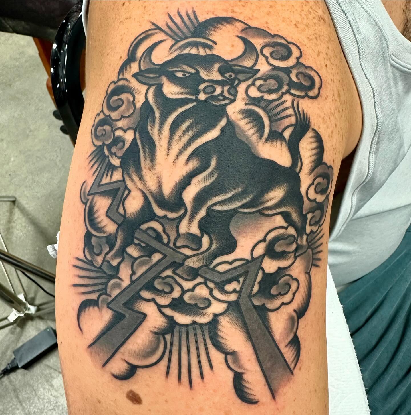 Bull and clouds American traditional tattoo on the thigh by Dave G
