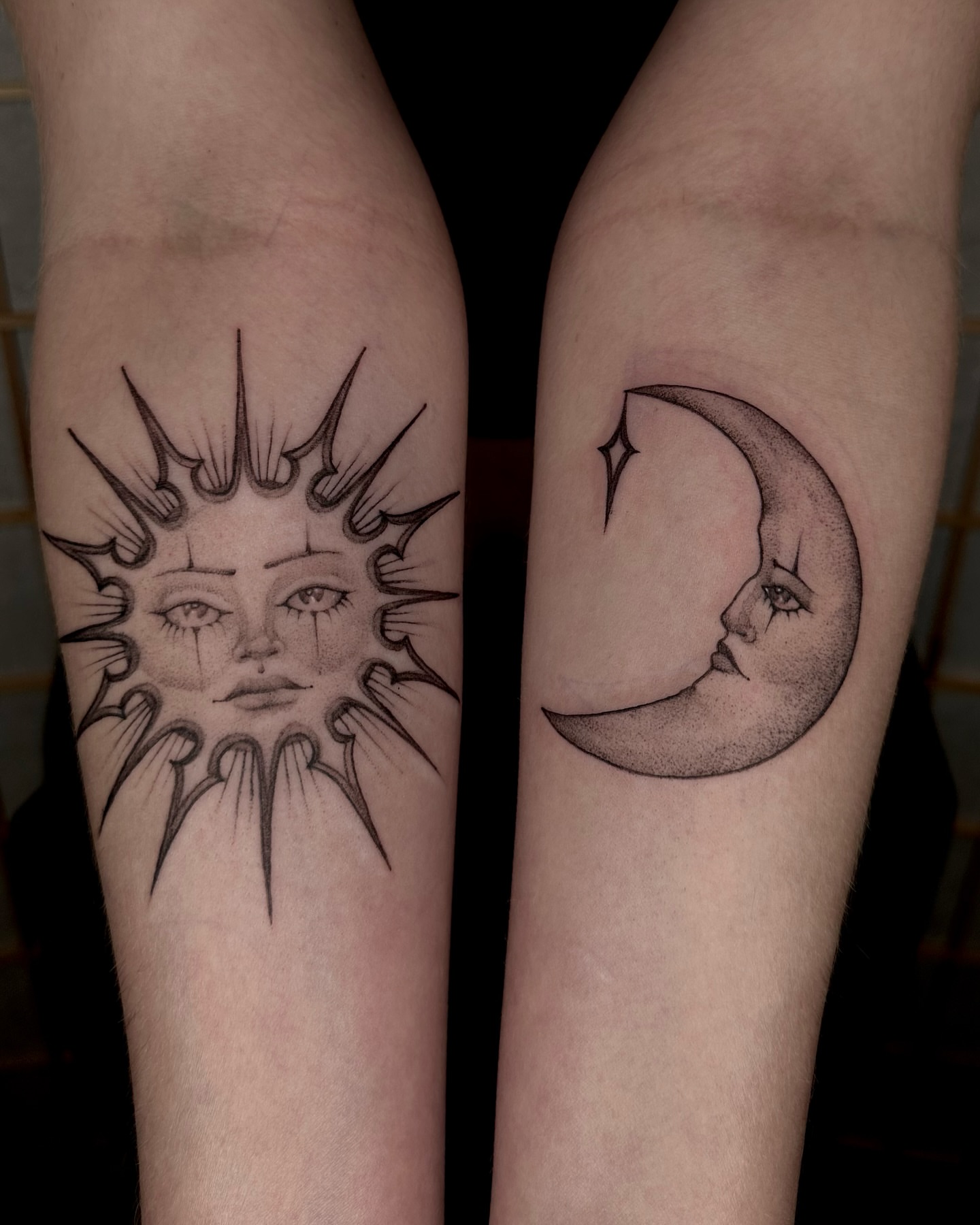 Sun and moon faces dotwork tattoo on the forearm by cora cupid