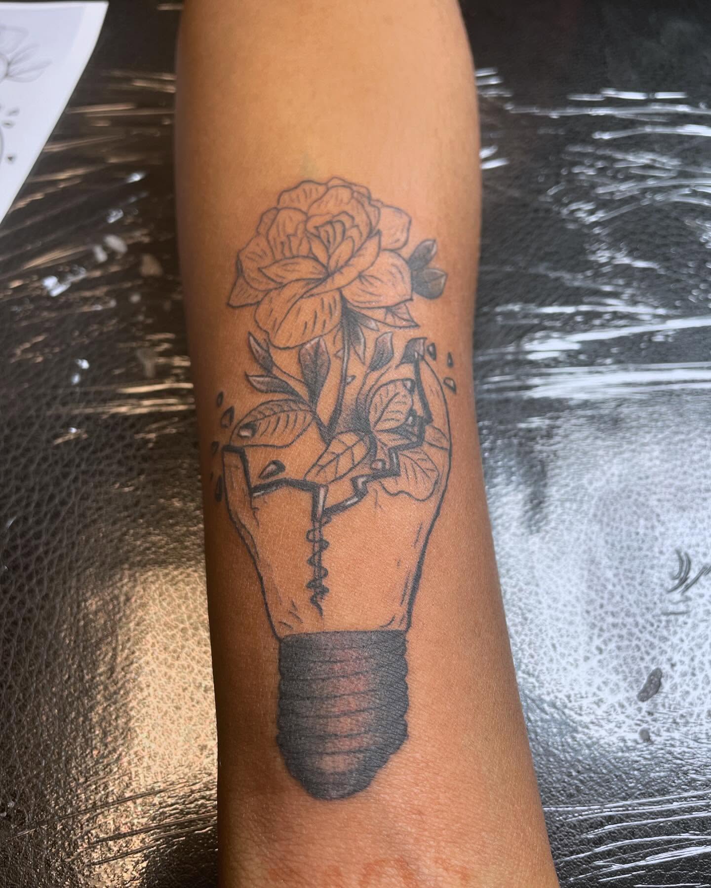 Flower in bulb black and grey tattoo on the forearm by Real Smuve