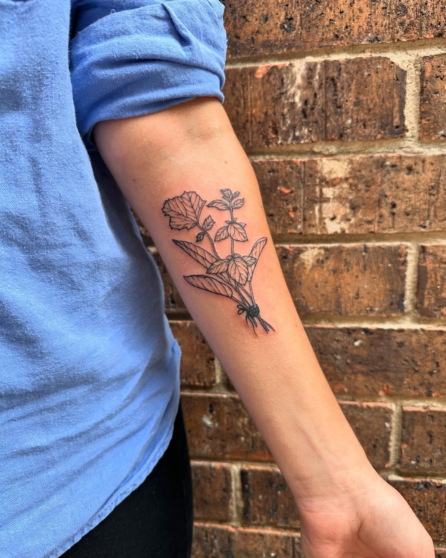 Plant bundle black and grey tattoo on the forearm by Emily ๐น