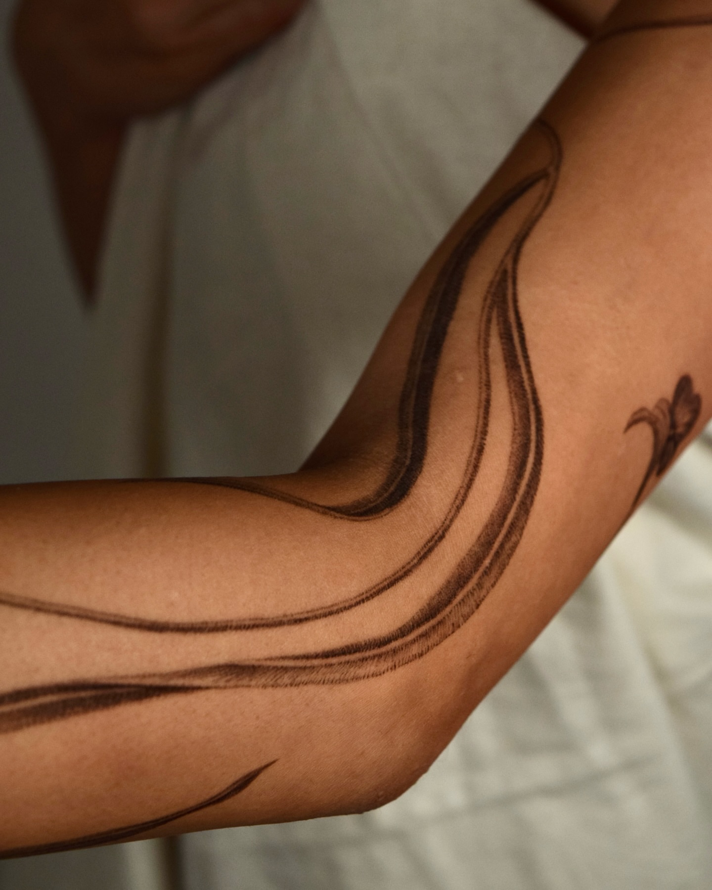 Abstract swirls black and grey tattoo on the forearm by Stella Oh