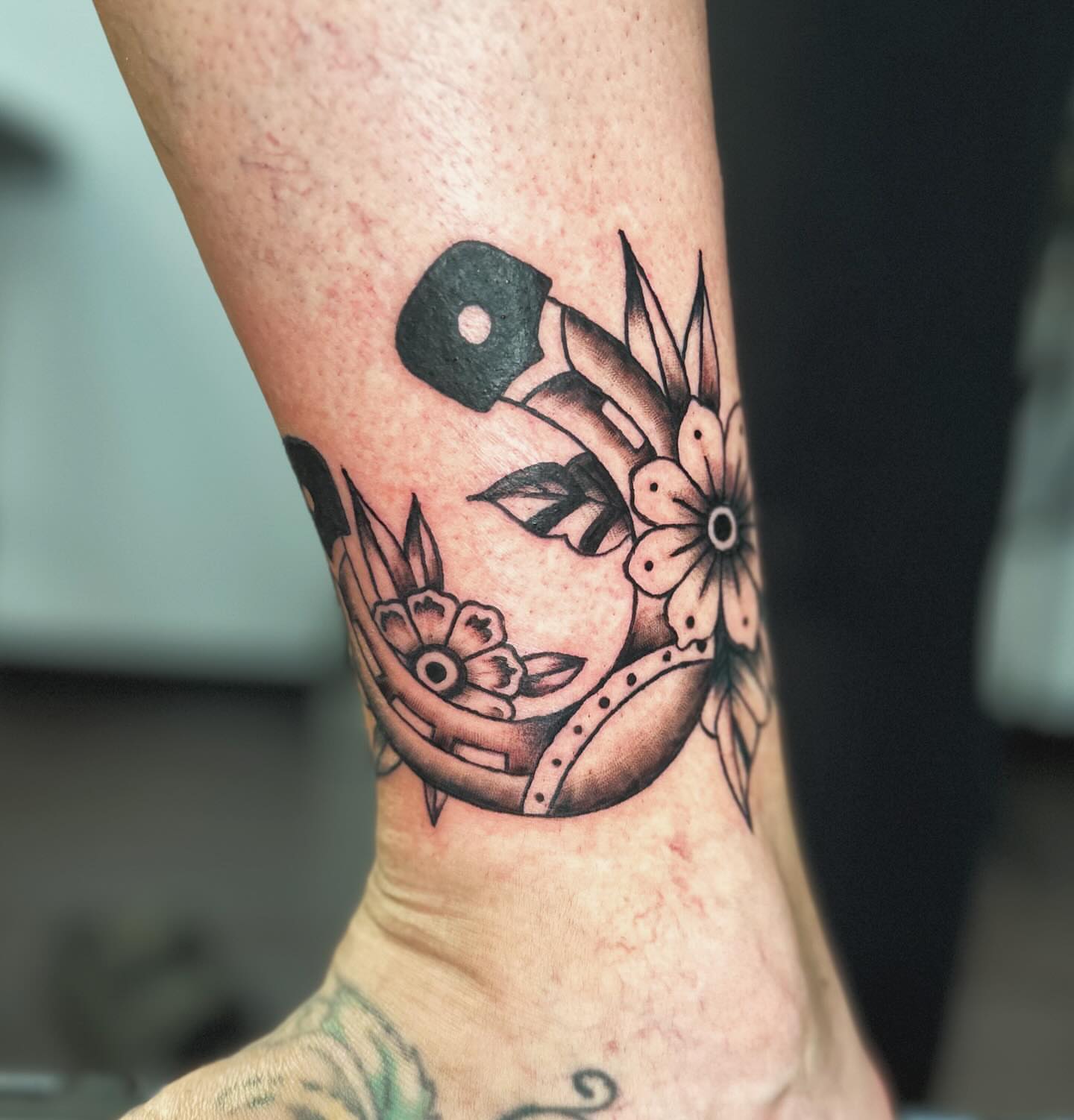 Mask and flowers black and grey tattoo on the forearm by πΎππ π π·ππ πππππ πΏπππππ π¬πππππ