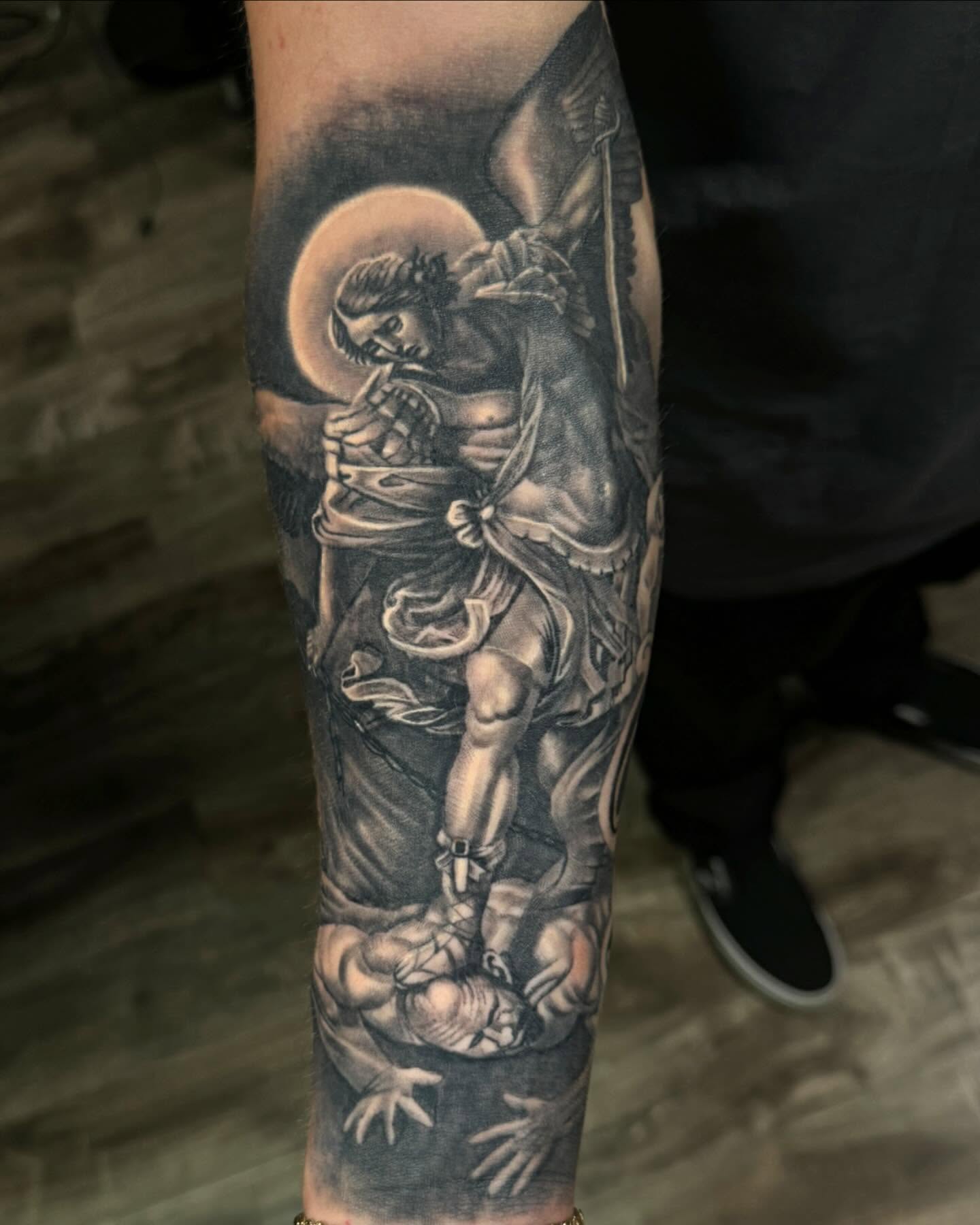 Saint and demon realism tattoo on the forearm by Anthony Duran