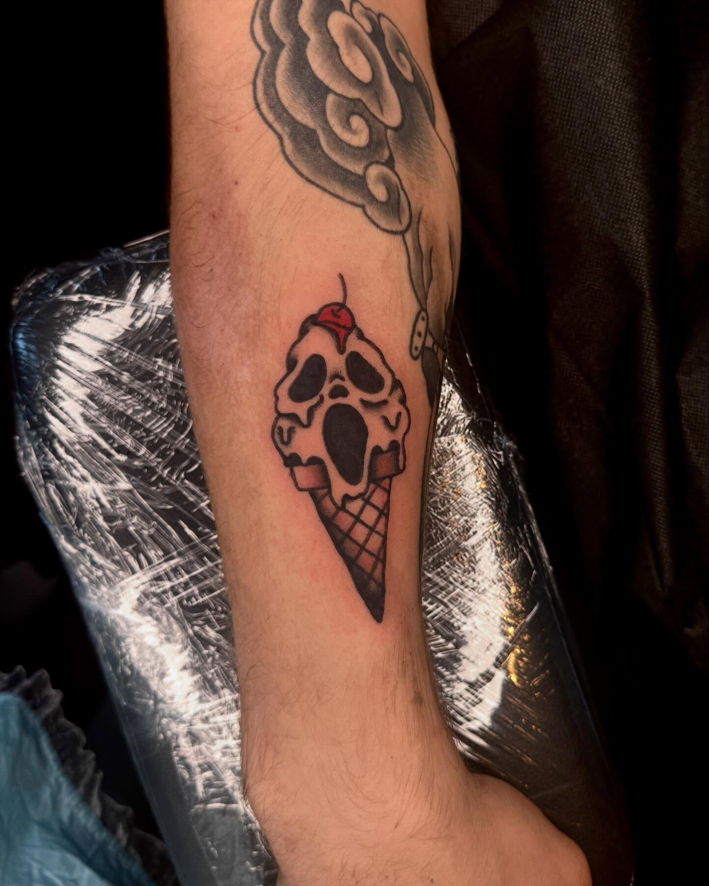 Ice cream cone skull black and grey tattoo on the forearm by Meg Nefcy, Milford, Michigan