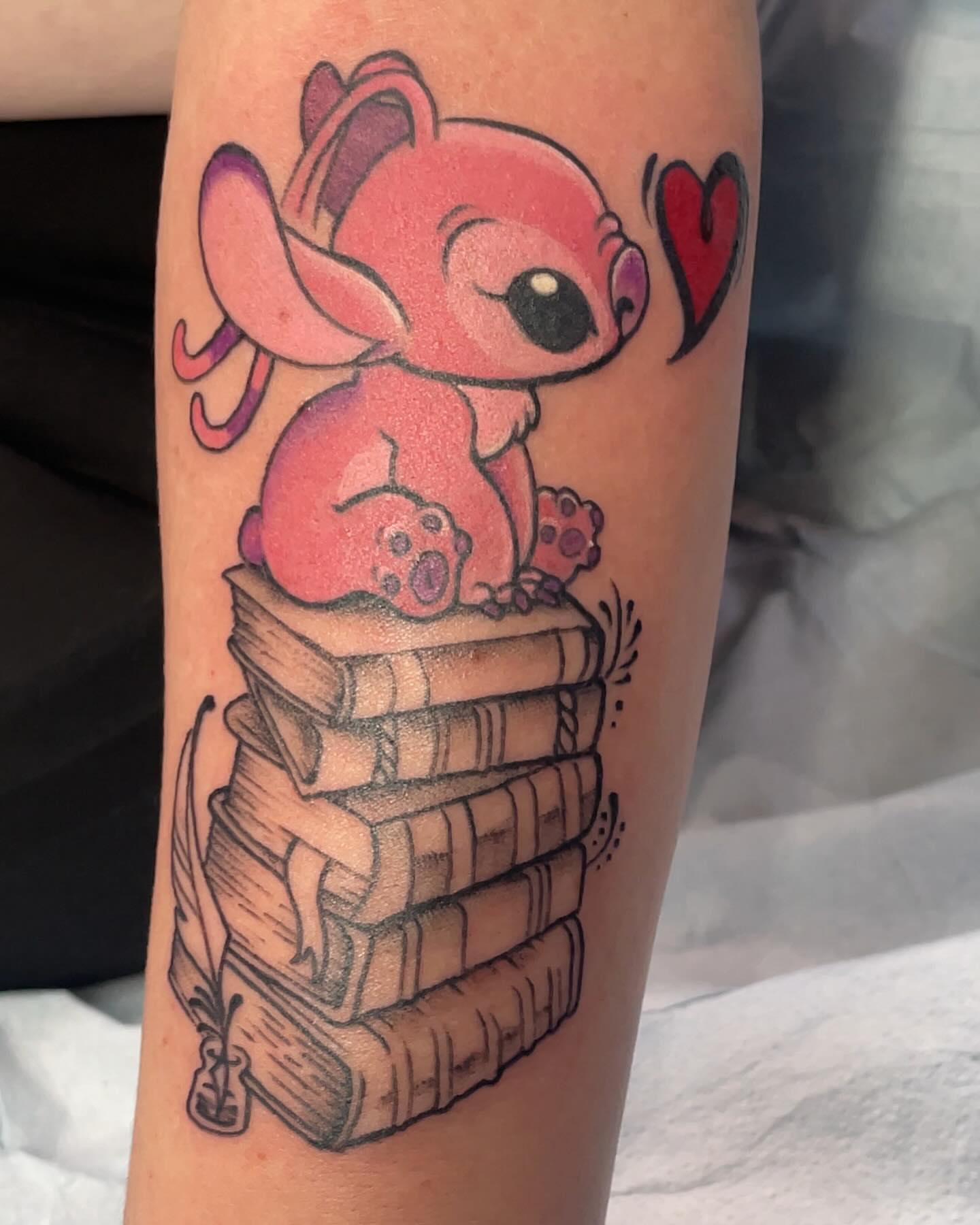 Stitch on books anime tattoo on the forearm by Robin Wintringham