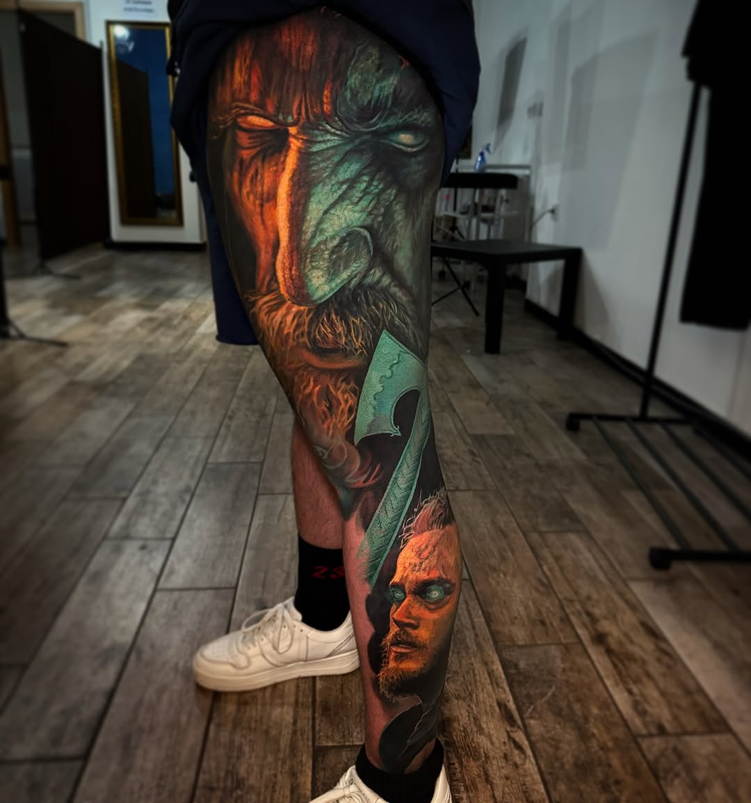 Viking warrior and axe realism tattoo on the leg by Tony Ink