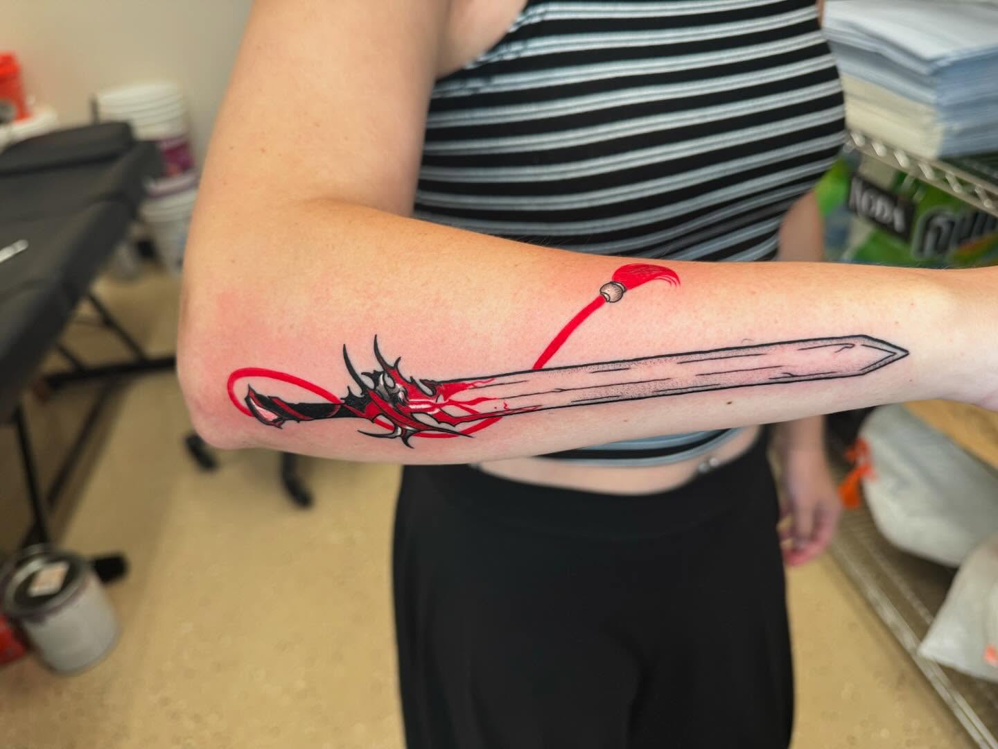 Sword and dragon anime tattoo on the forearm by Ian Chancellor, Leighton Buzzard, England