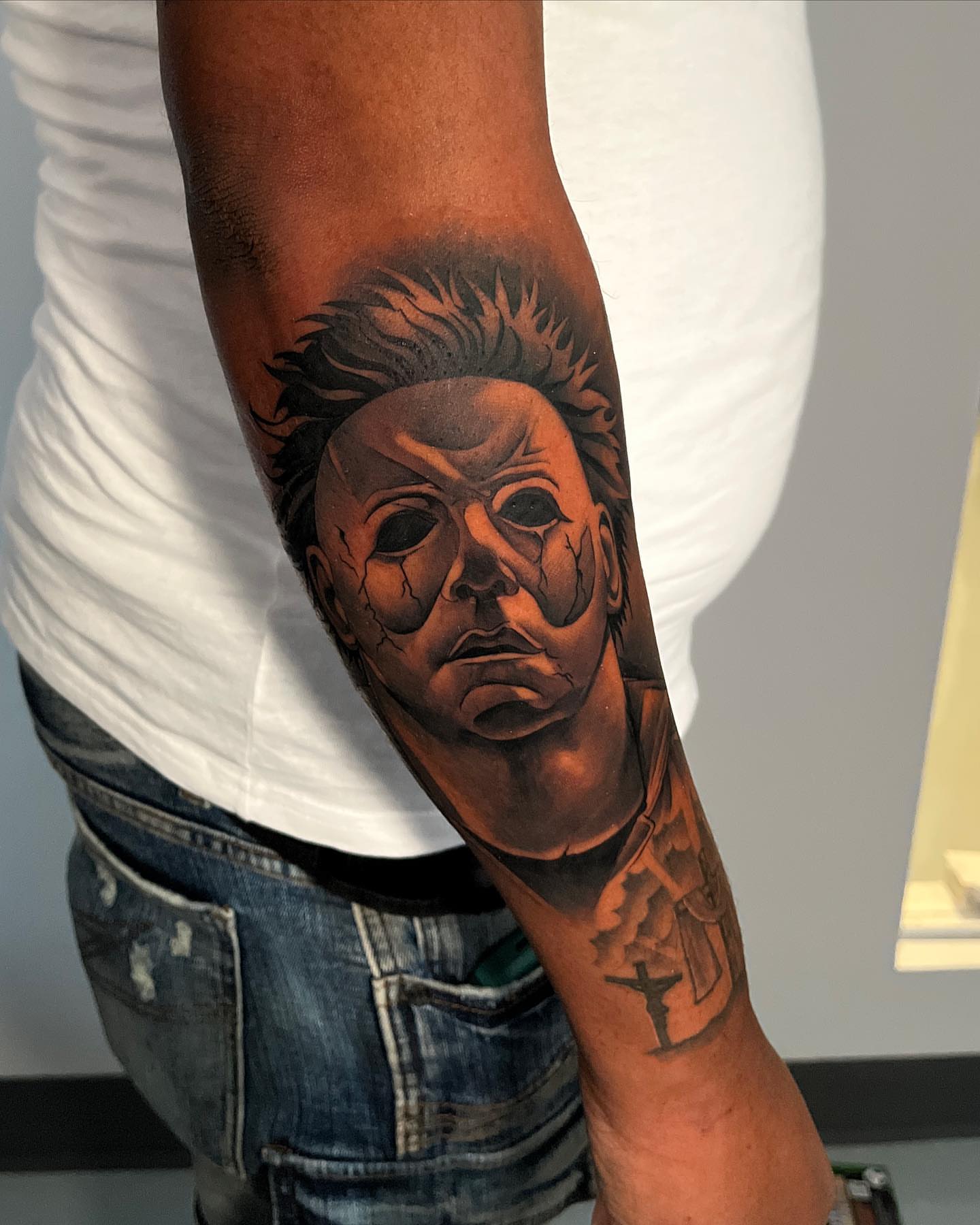 Michael Myers mask realism tattoo on the forearm by Miles Johnson