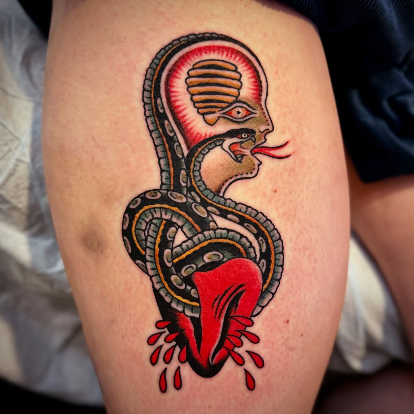 Snake American traditional tattoo on the thigh by Pavel