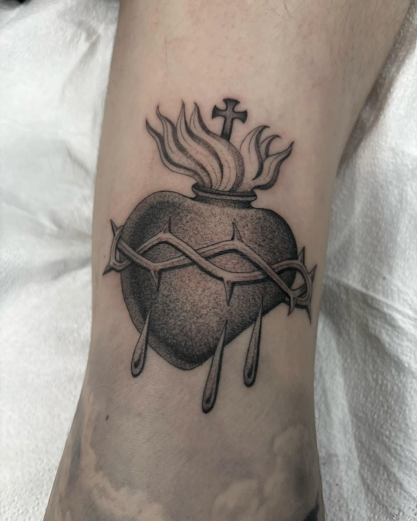 Heart with crown of thorns dotwork tattoo on the forearm by Jake Hodson, Nashville, Tennessee
