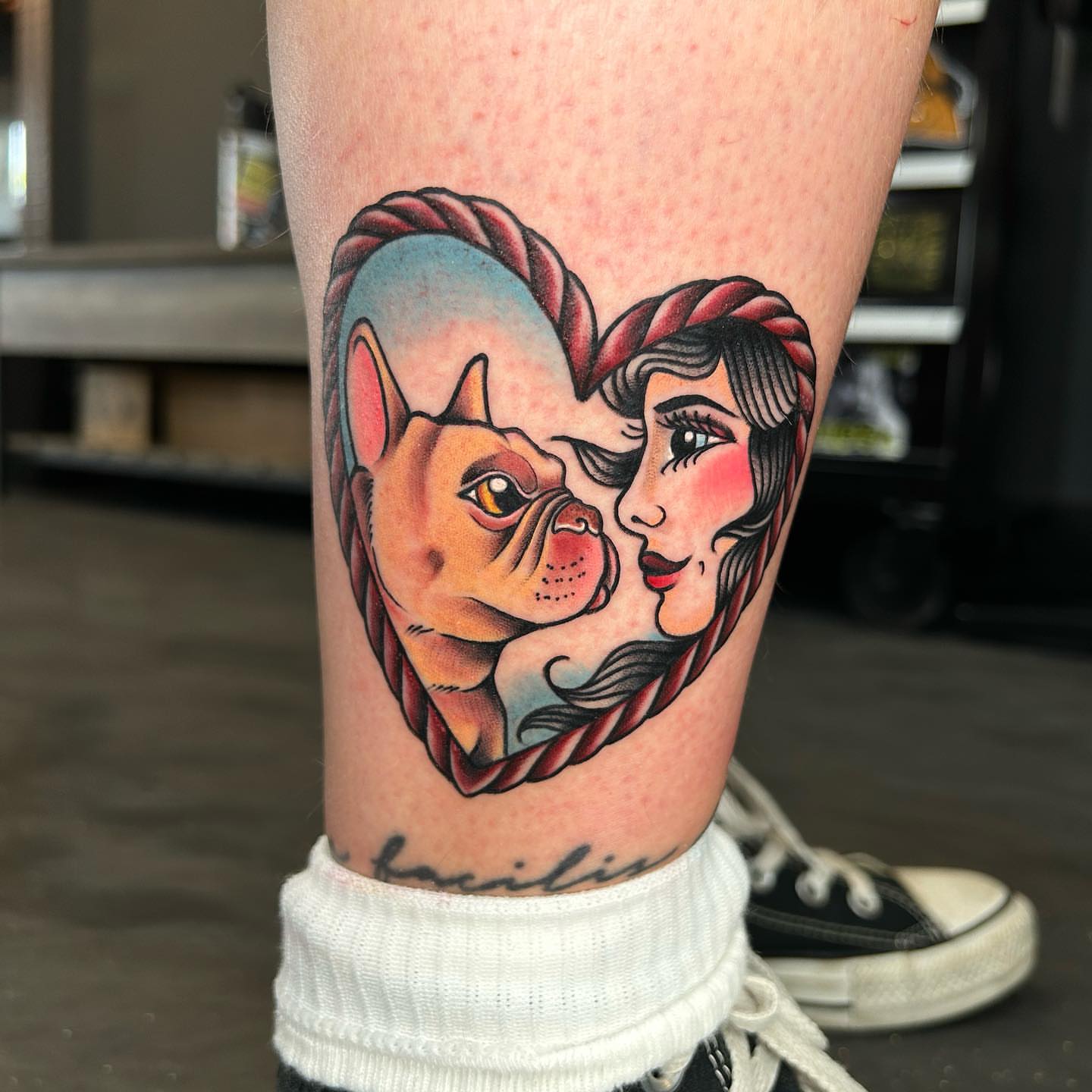 Dog and woman American traditional tattoo on the forearm by Lexi Kniskern