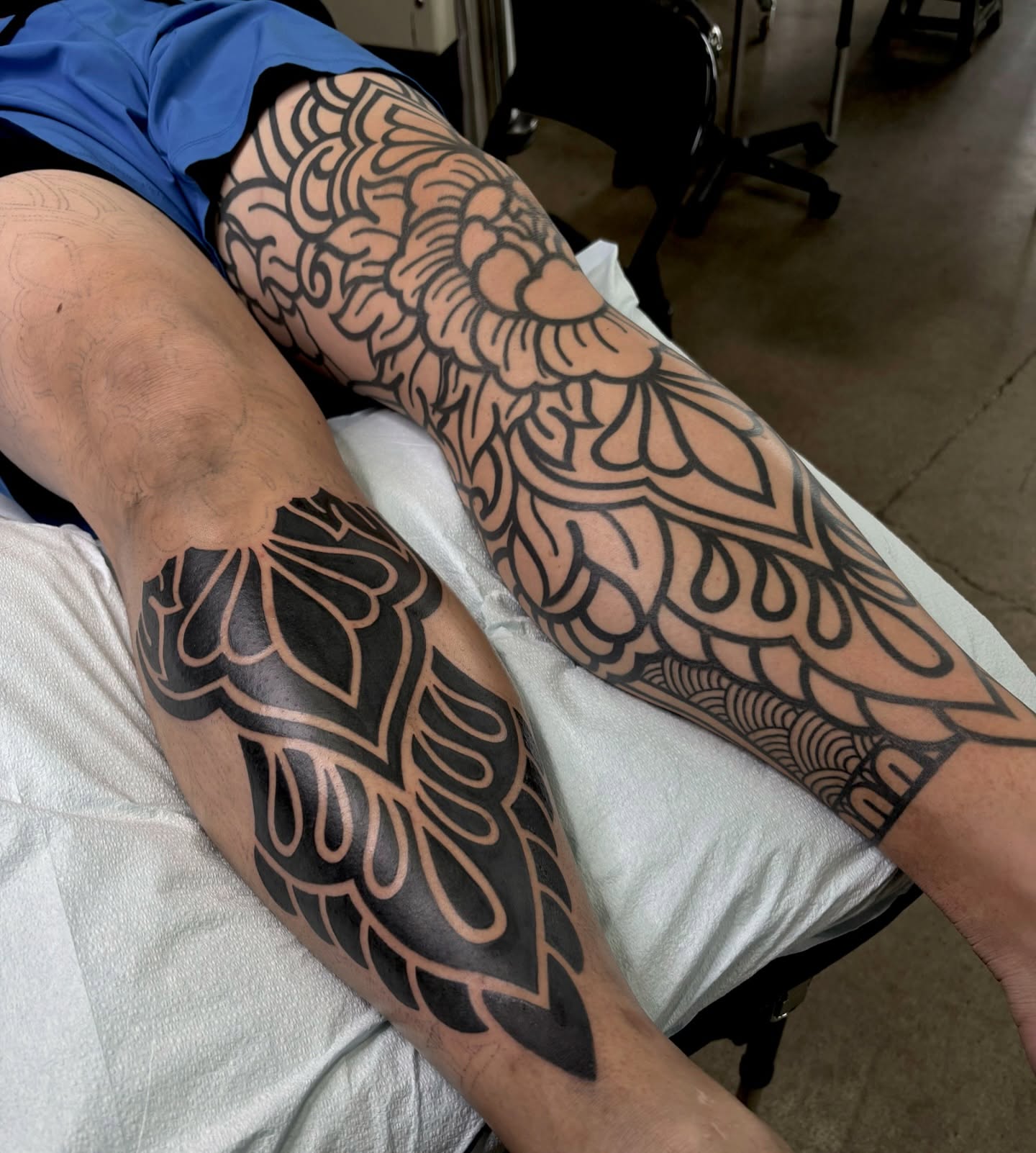 Floral pattern black and grey tattoo on the leg by Kolbi Alexis