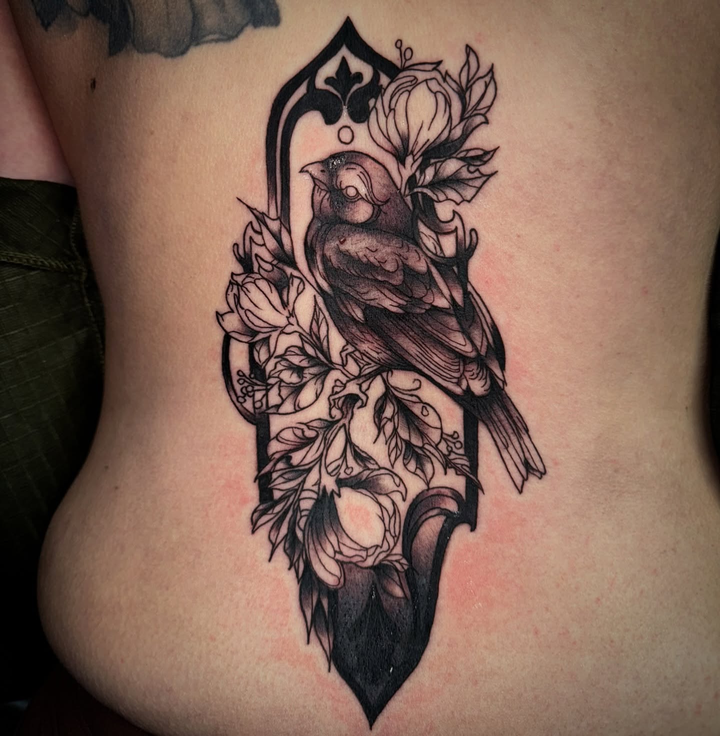 Bird and floral arrangement realism tattoo on the ribs by Therapy ink