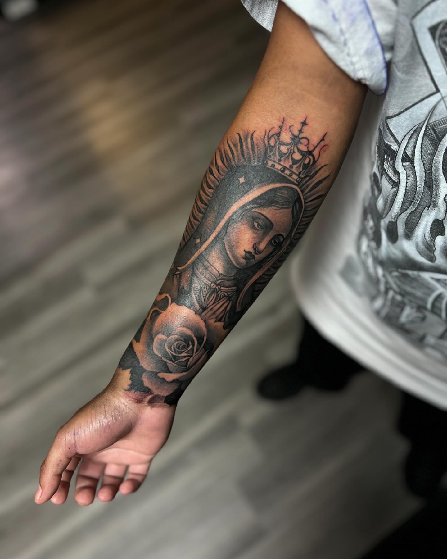 Religious figure with crown realism tattoo on the forearm by Smuk One