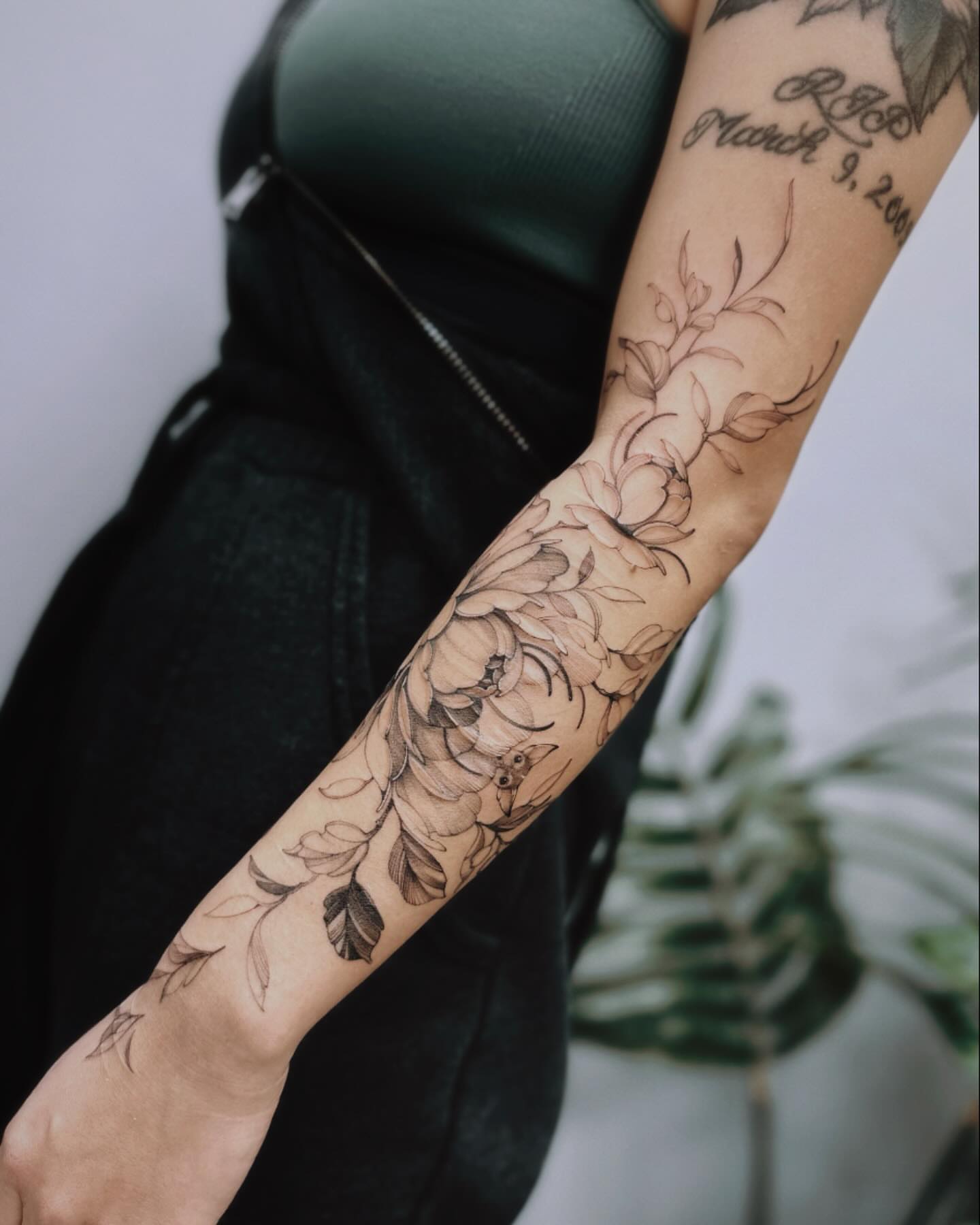 Floral bouquet black and grey tattoo on the forearm by Angel