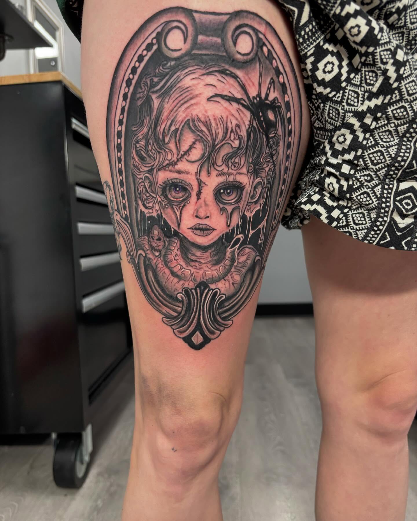 Doll head realism tattoo on the thigh by Alyssa Turner