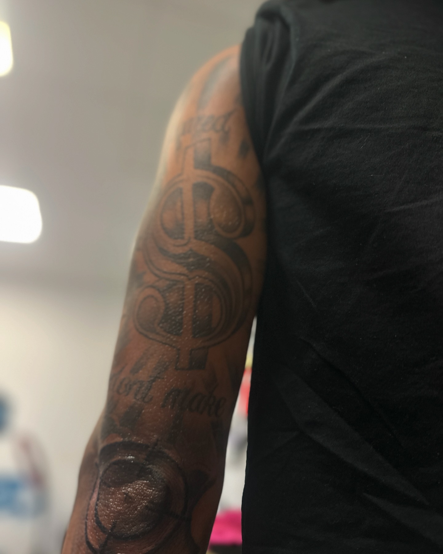 Dollar sign black and grey tattoo on the forearm by ᴡᴏʀᴍ