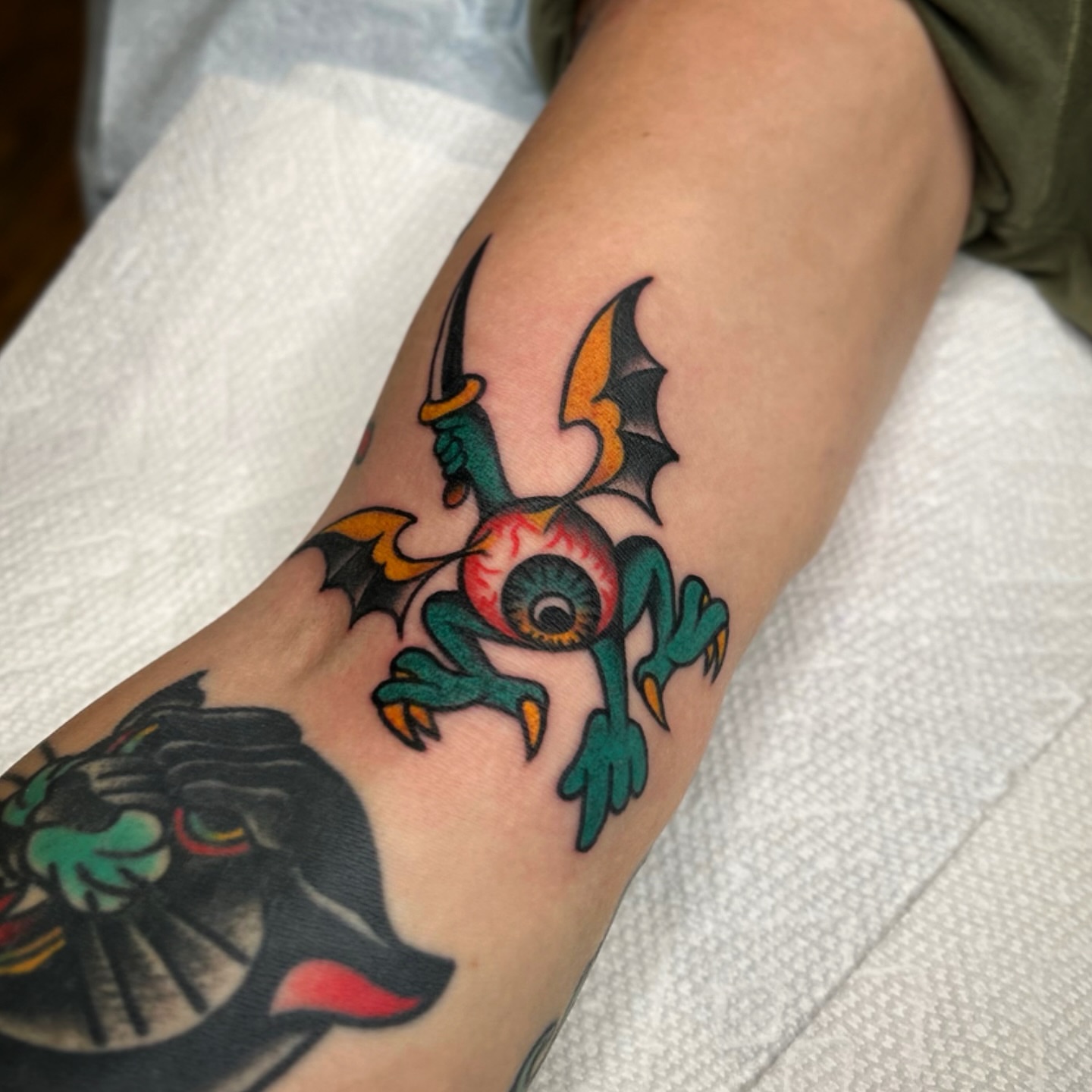 Eye with bat wings American traditional tattoo on the forearm by Bright-bold-classic Tattoos, North Hills