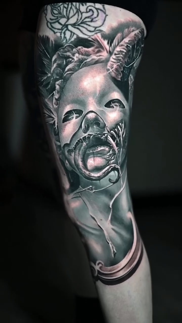 Distorted baby face with snake dark realism tattoo by Jerrel Larkins