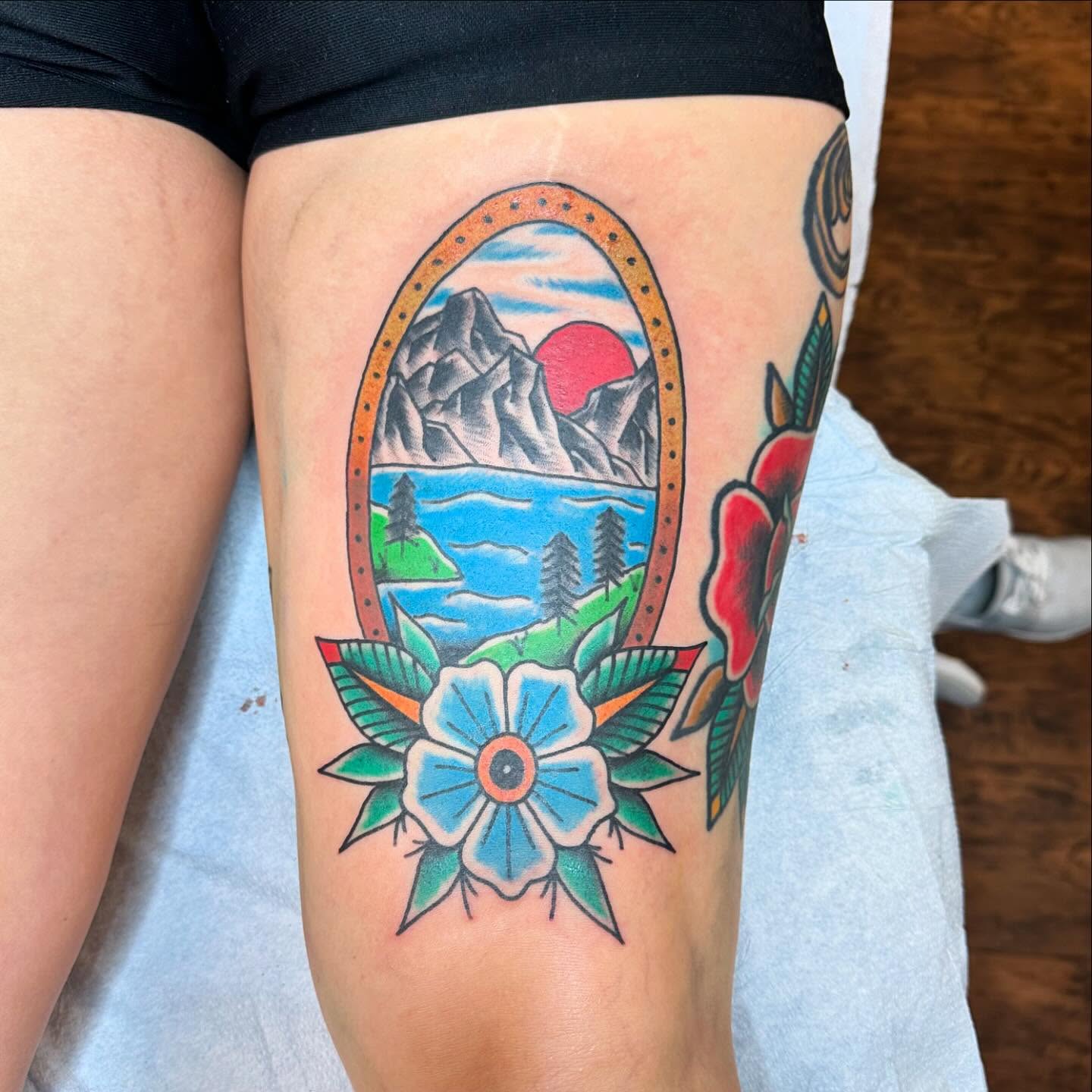 Mountain landscape American traditional tattoo on the thigh by Jackie