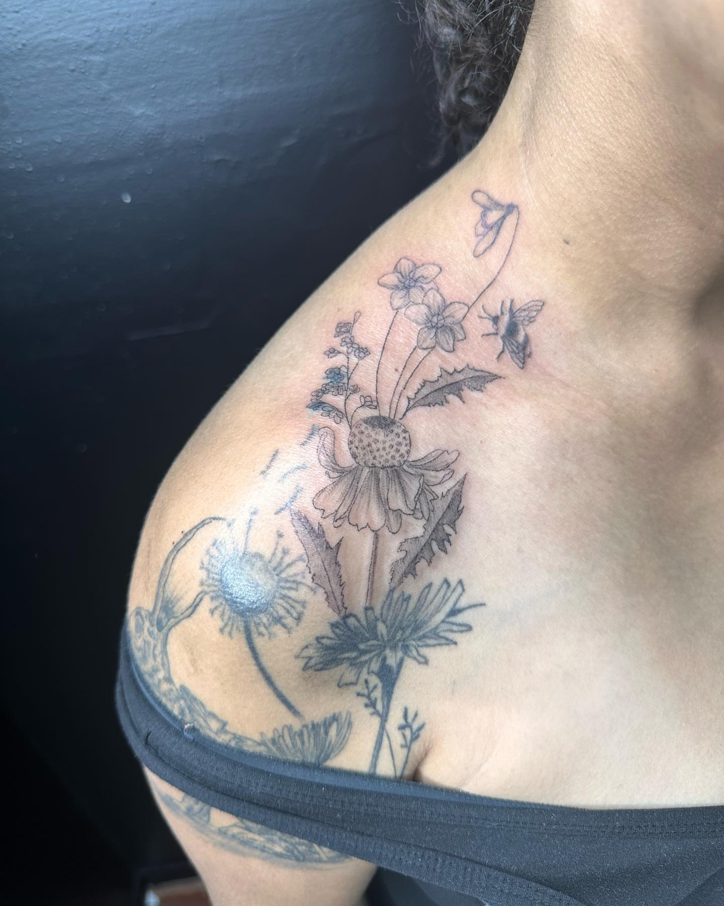 Wildflowers and bee black and grey tattoo on the shoulder by Kat π