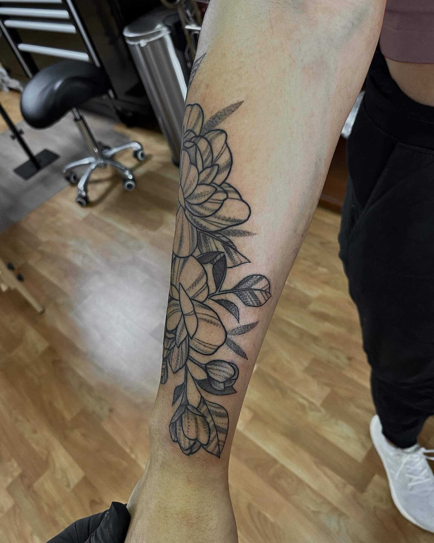 Floral bouquet black and grey tattoo on the forearm by Taya Lynn, Hudson, Wisconsin
