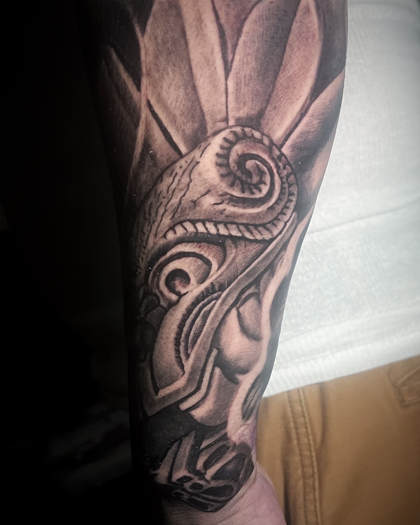 Mask with snake realism tattoo on the forearm by David Gray
