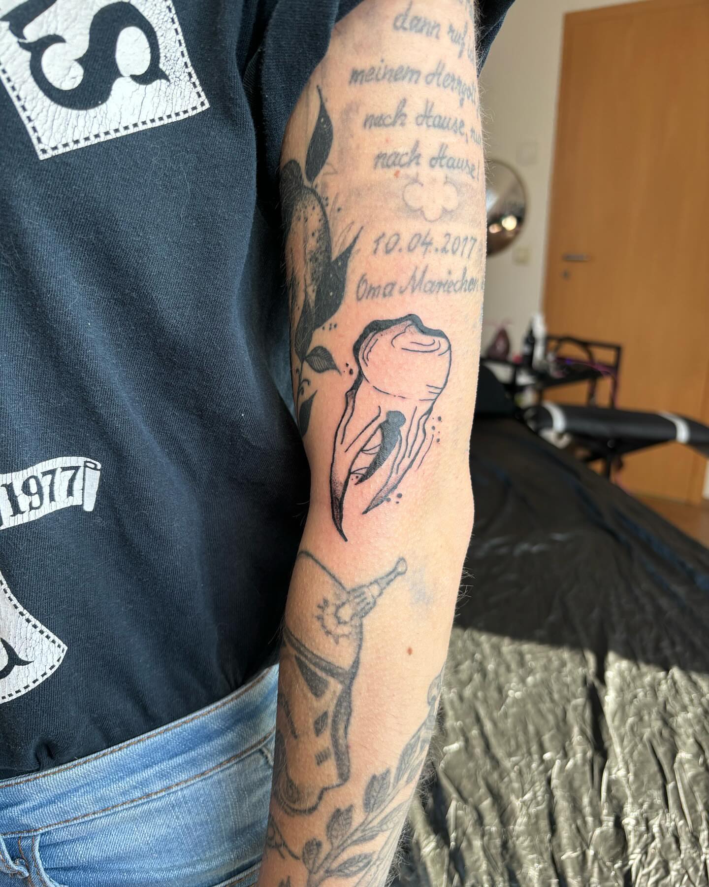 Tooth and flower black and grey tattoo on the forearm by lu ๐