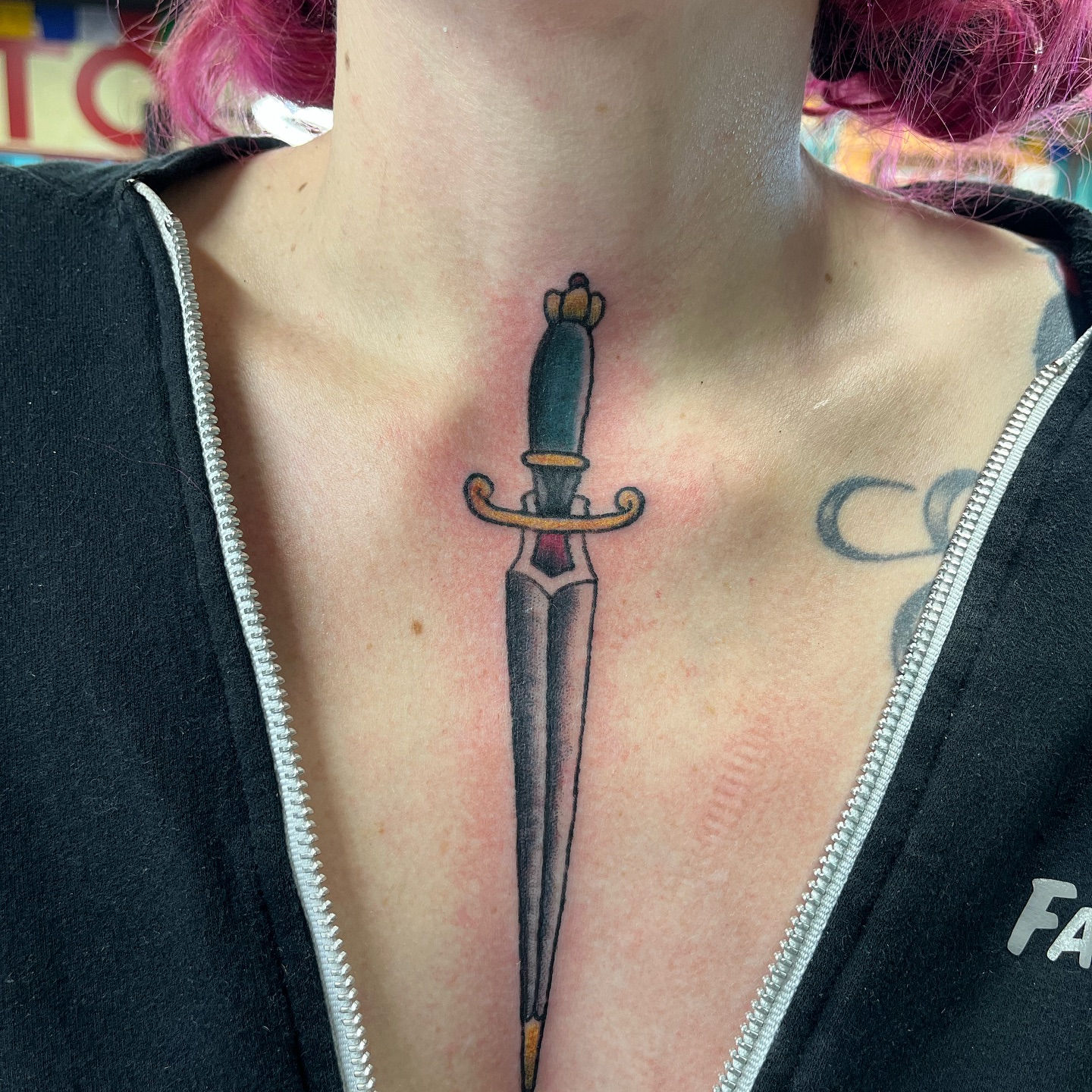 Sword American traditional tattoo on the chest by Ashley Camp