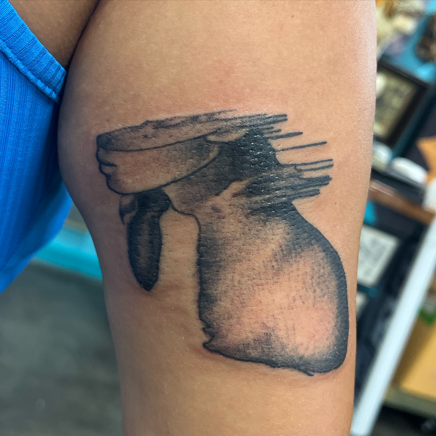 Woman black and grey tattoo on the thigh by Ashley Camp