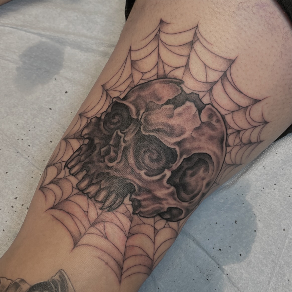 Skull black and grey tattoo on the forearm by JoDee Yates