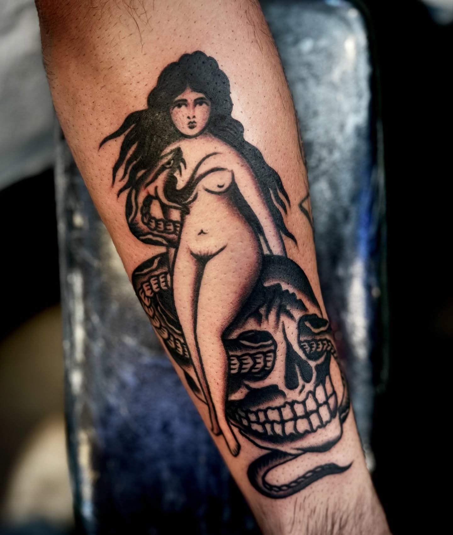 Naked woman with snake realism tattoo on the forearm by Pavel