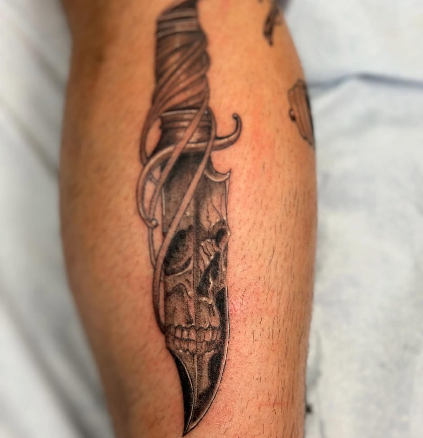 Skull and dagger realism tattoo on the forearm by Amber Lynn