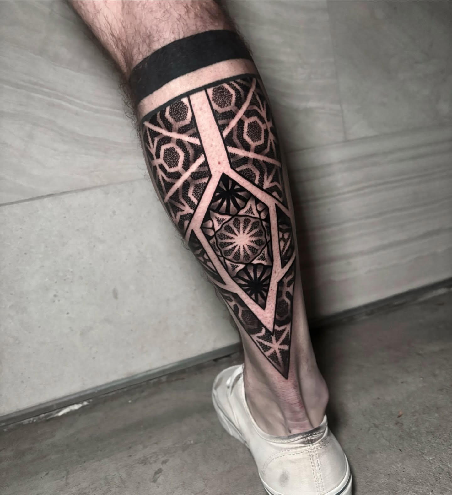 Geometric pattern geometric tattoo on the calf by Eric Hare